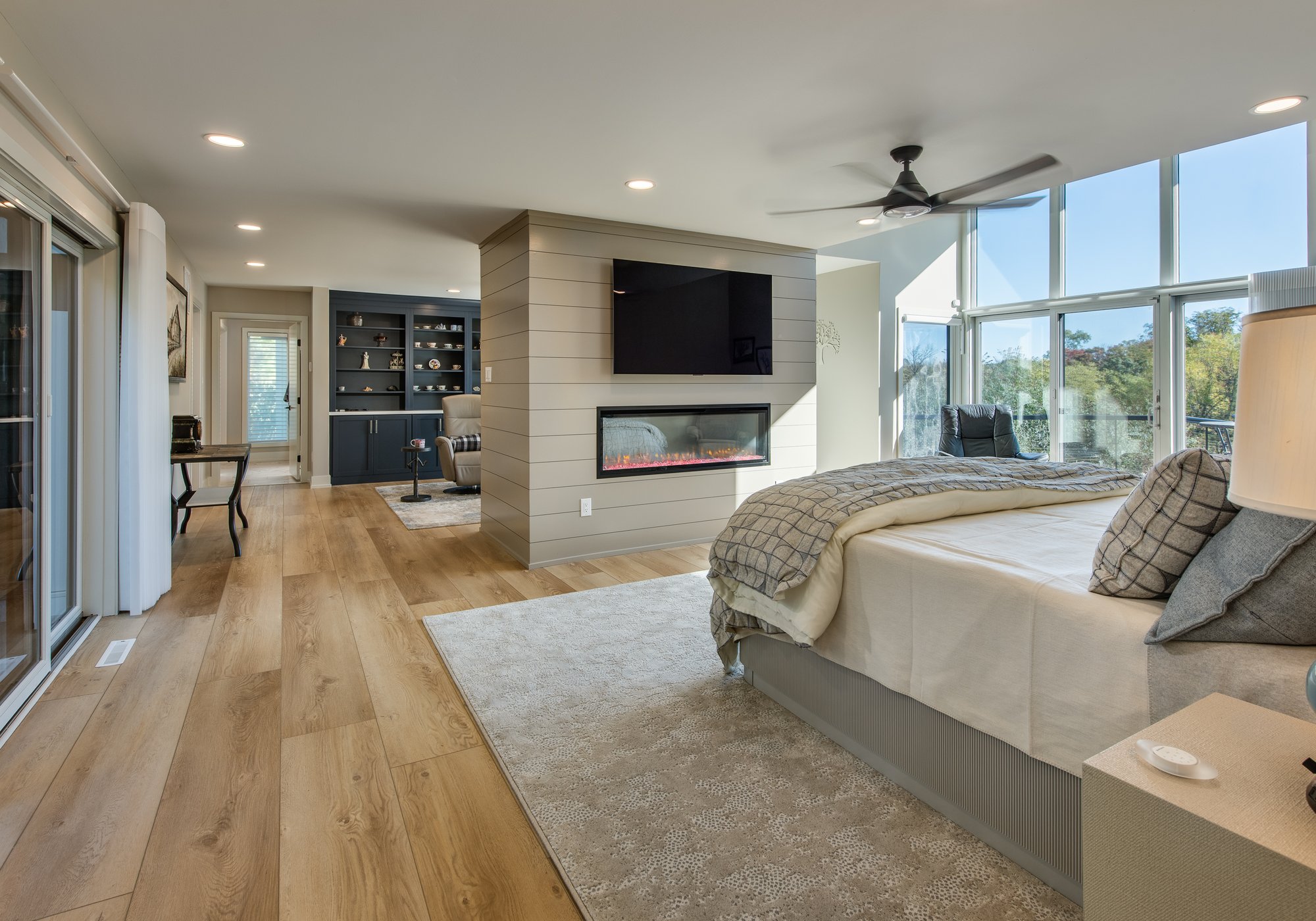 Primary bedroom remodel featuring hardwood floors, floor-to-ceiling windows, and a sitting area
