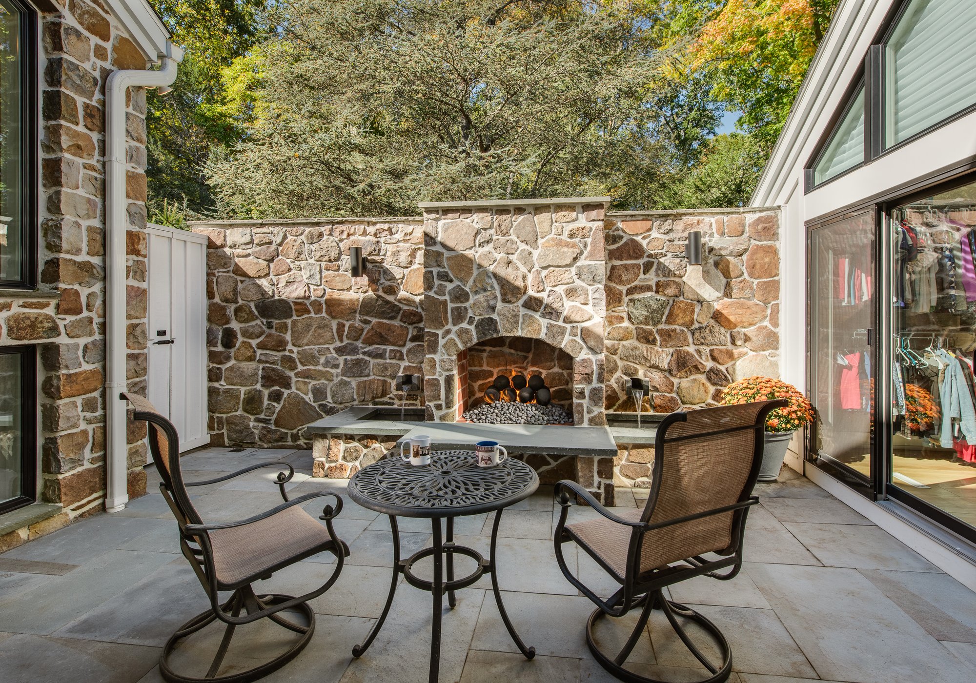 A custom private courtyard off a primary bedroom with a custom stone fireplace