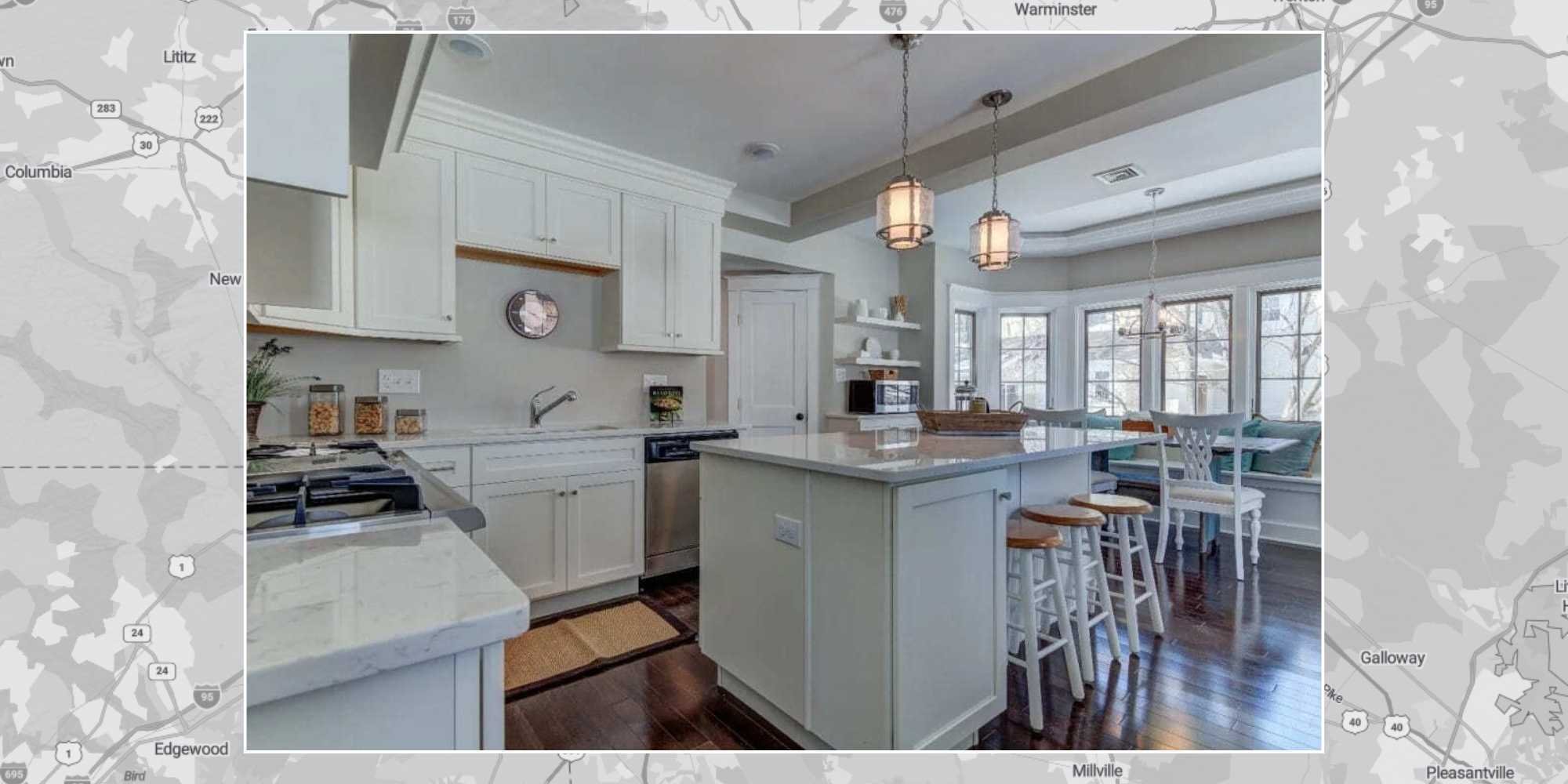 Image of a bright white kitchen remodel with custom cabinetry and window nook by Thompson Communities