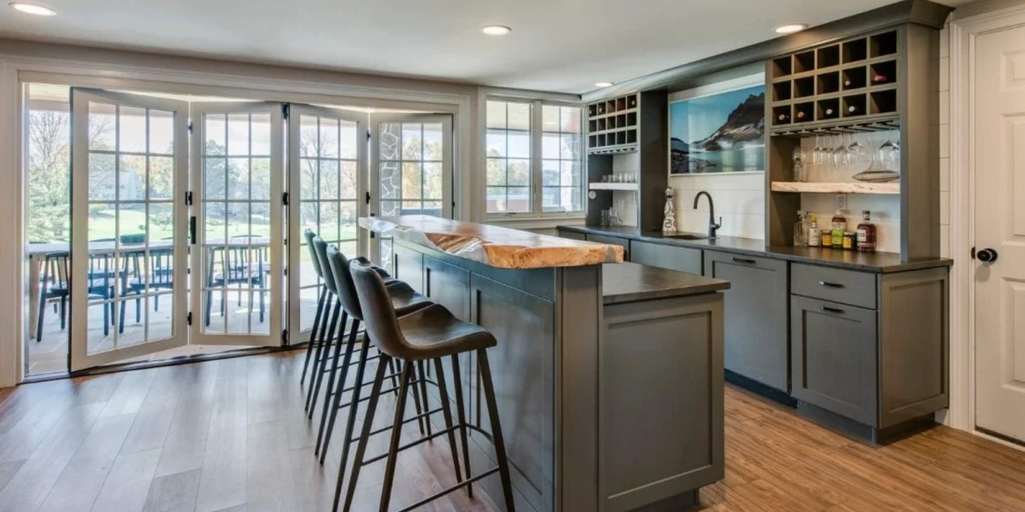 Built-in bar area with wine storage, black cabinetry, and natural wood accents in Tri-State home