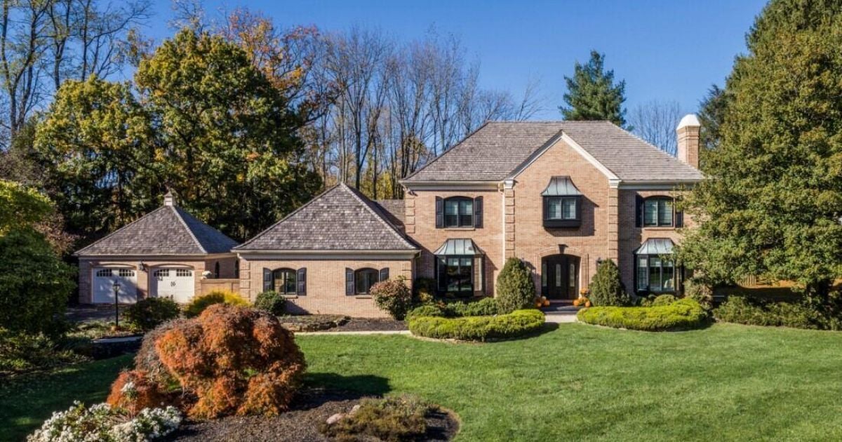 Custom-built brick estate home in West Chester with black shutters and detached garage by Thompson Communities