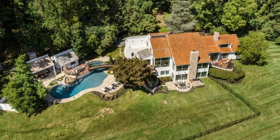 Luxury outdoor living space by Thompson Communities featuring pool and cabana design