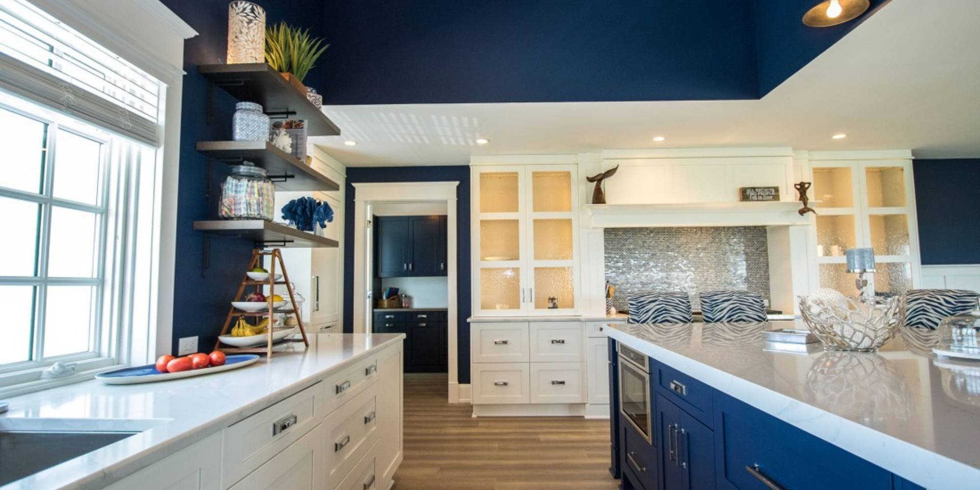 Remodeled kitchen with large island and plenty of storage by Thompson Communities