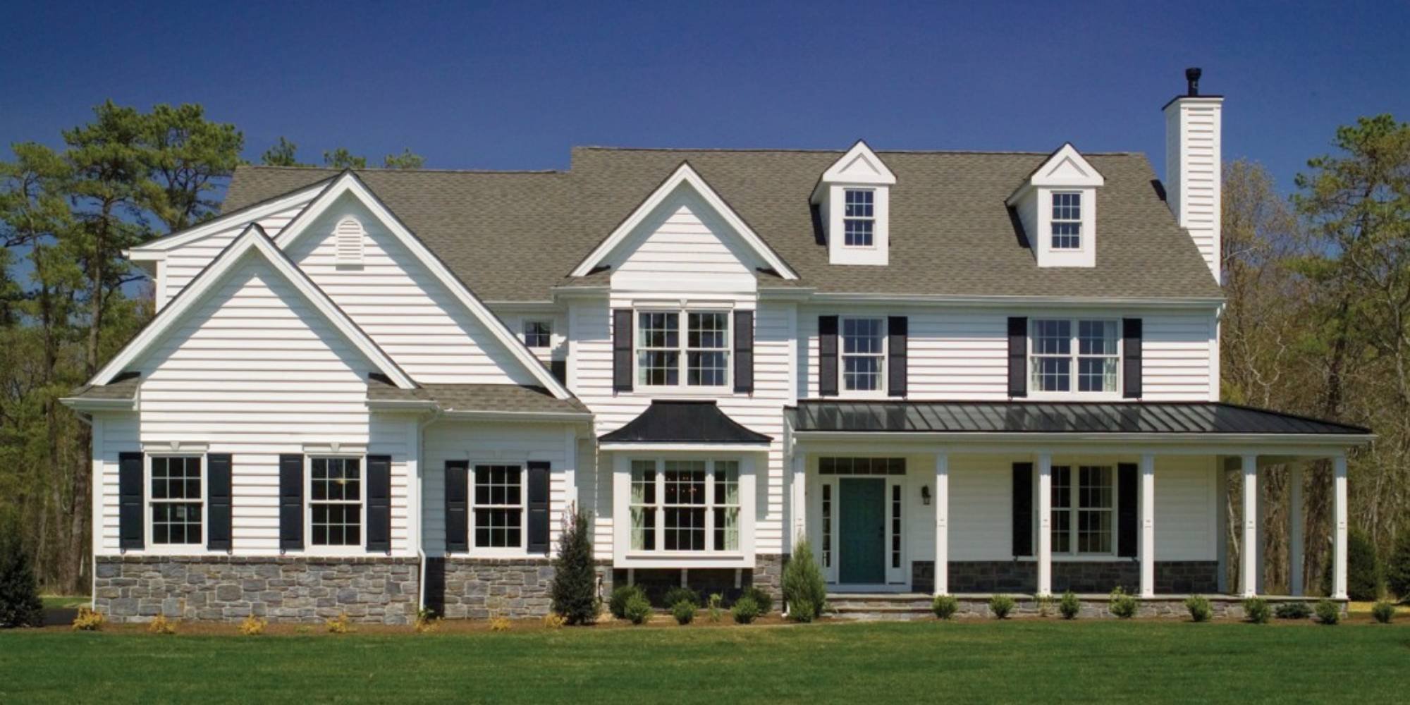Image of custom white farmhouse-style home with covered front porch in West Chester, PA by Thompson Communities