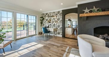 Image of a remodeled living room with wood floors and brick fireplace in West Chester, PA
