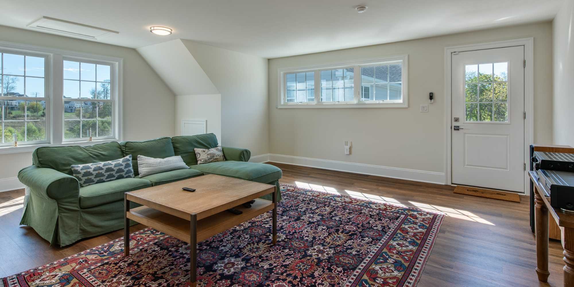 Over-the-garage addition used as living room or guest suite by Thompson Communities