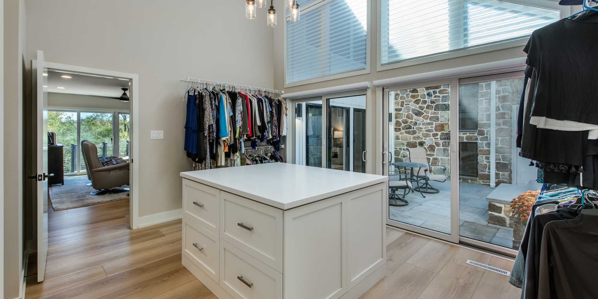 Spacious walk-in closet with center island in primary bedroom, Chester County