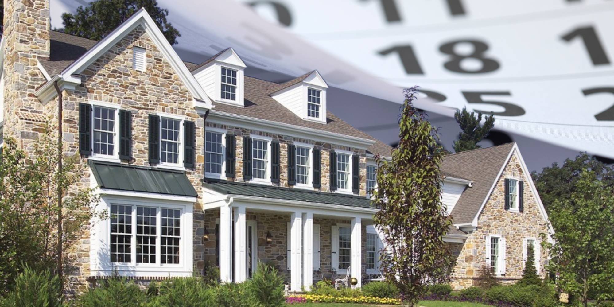 Stone exterior Pennsylvania home with black shutters, front porch, and lush landscaping