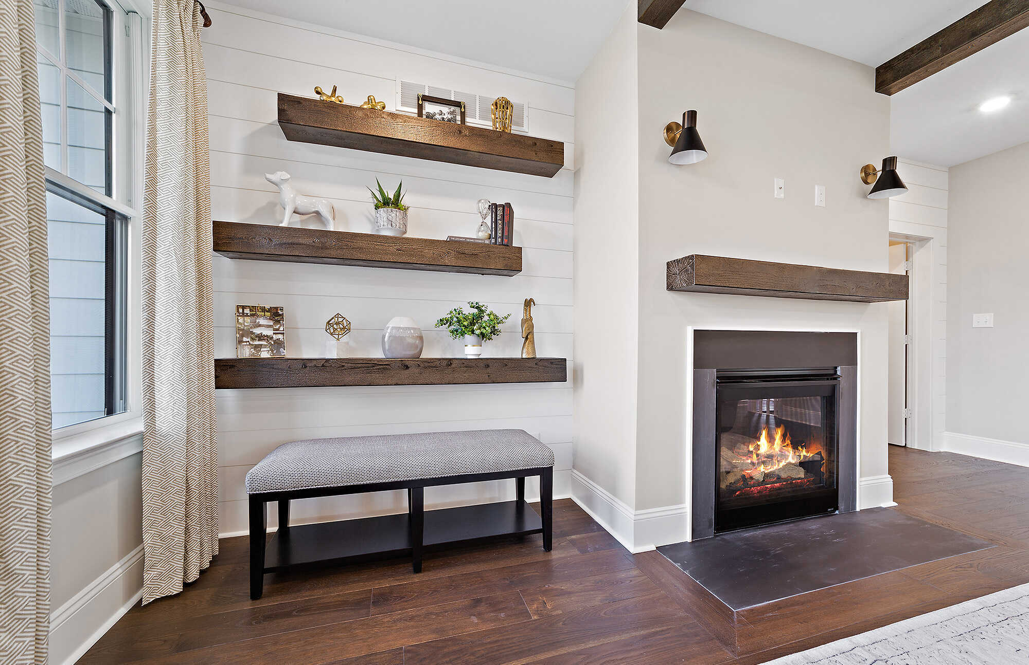 Cozy living room with a fireplace and rustic wood shelving, Thompson Communities project, West Chester, PA