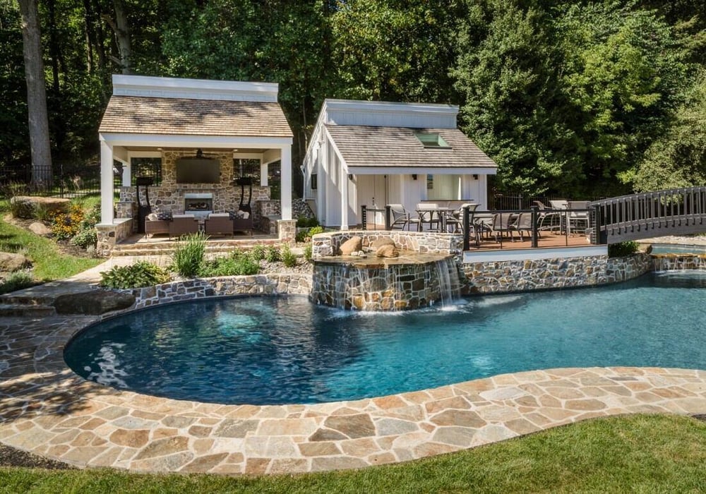Backyard oasis with a pool and pavilion in West Chester, PA, home addition by Thompson Communities