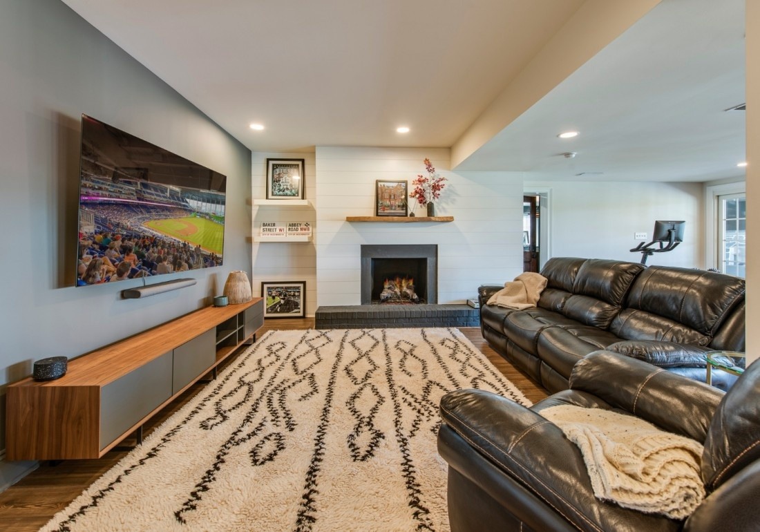 Cozy basement entertainment room in West Chester, PA home addition by Thompson Communities