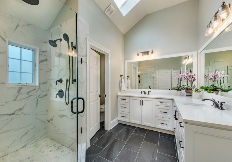 Spacious bathroom with a glass shower and double vanity, part of a remodel by Thompson Communities in West Chester, PA - Thompson Communities - 