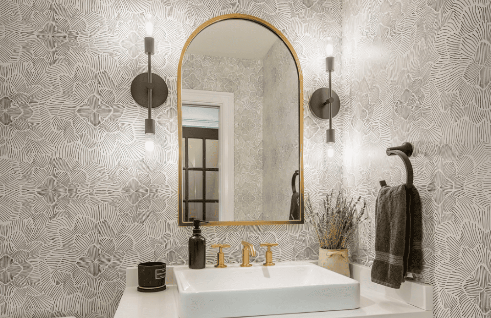 Gold mirror and faucet bathroom with brown and white floral wallpaper - Thompson Communities - Chester County Builder and Remodeler  