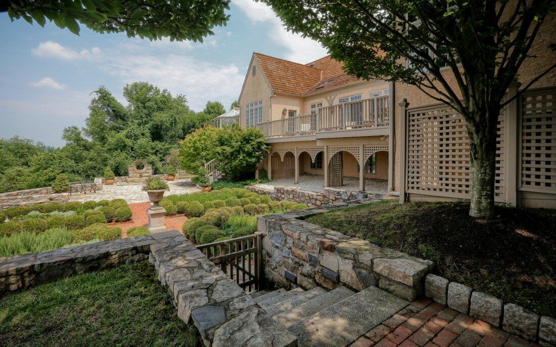 Large estate with stone walkway and front patio surrounded by shrubbery - West Chester PA | Thompson Communities