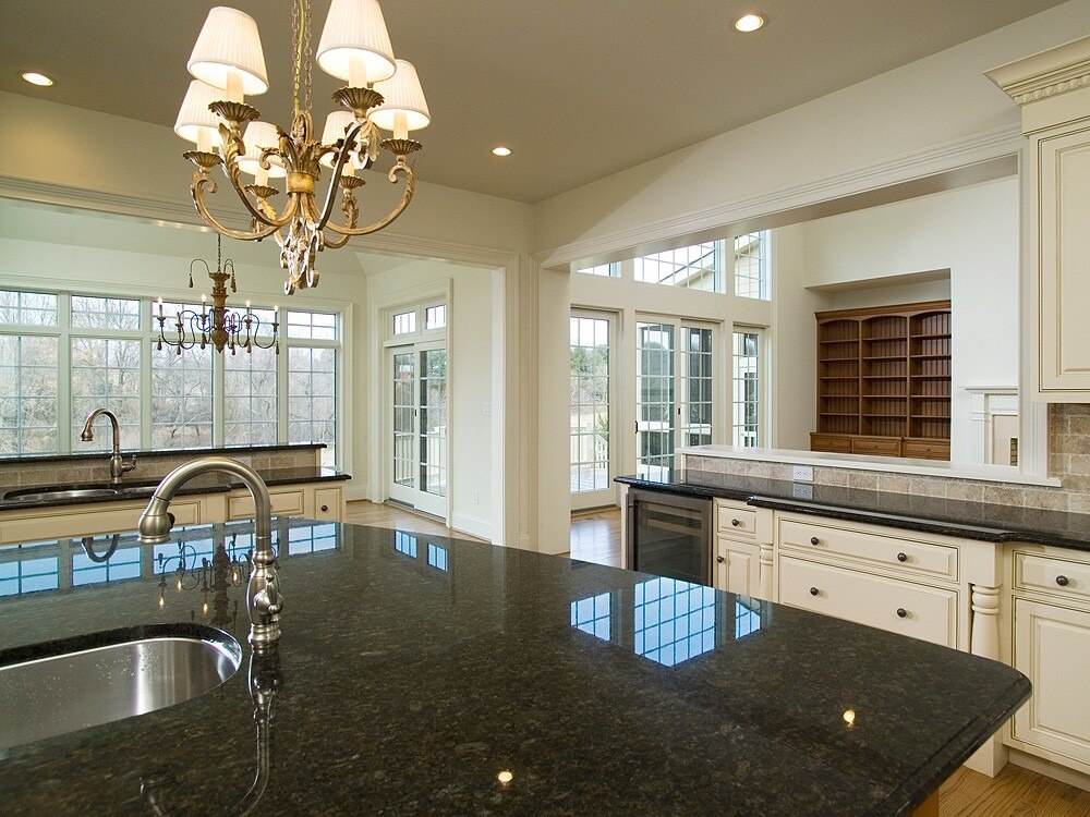 Luxurious kitchen design with granite countertops and chandeliers - Kitchen Remodel Process & Timeline- Thompson Communities - Chester County Builder and Remodeler