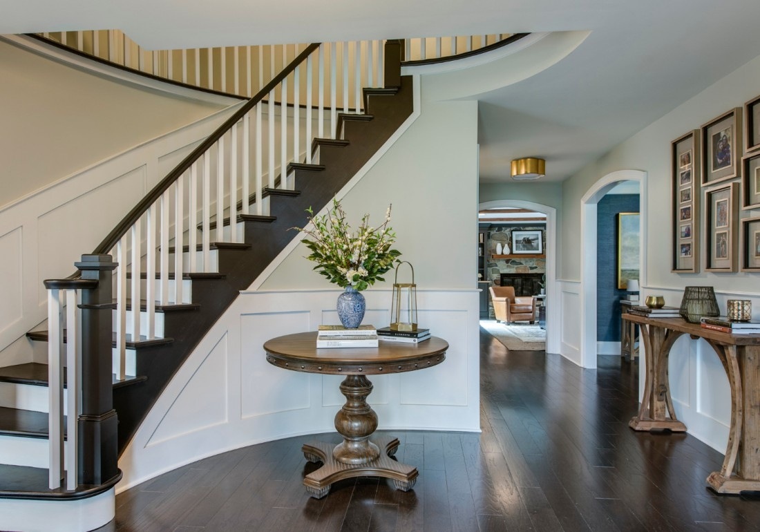 Stylish wine room with dark wood cabinetry and leather seating, Thompson Communities remodel, West Chester, PA