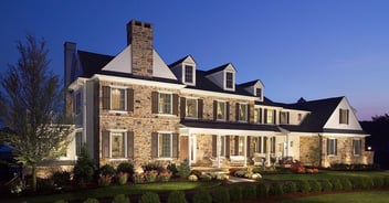 Custom Home built in West Chester with a stone facade, dormer windows, and landscaping by Thompson Communities