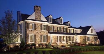 Custom Home built in West Chester with a stone facade, dormer windows, and landscaping by Thompson Communities