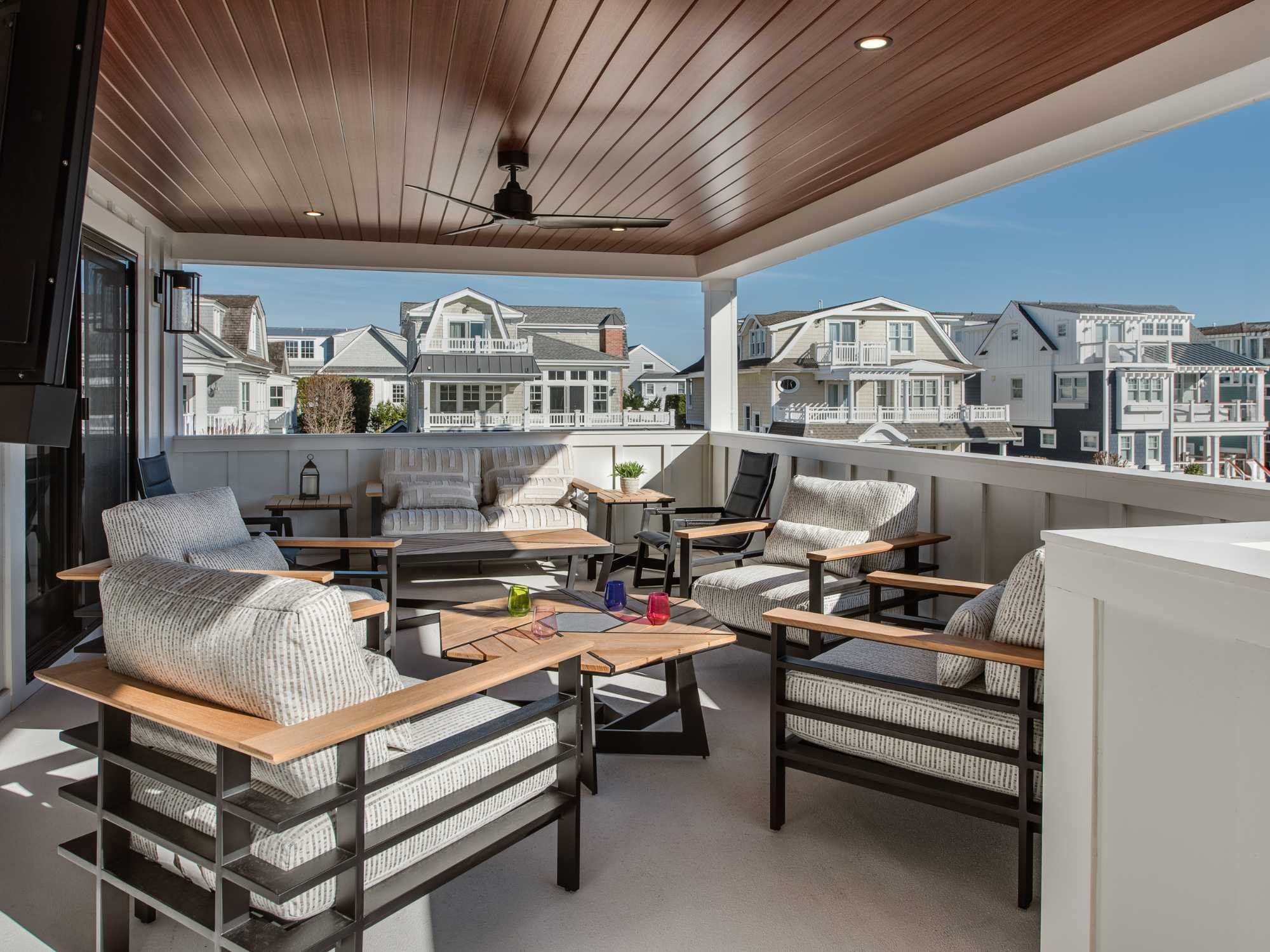 A covered deck on the second floor of a custom home with comfortable seating by Thompson Communities in Avalon A covered deck on the second floor of a custom home with comfortable seating by Thompson Communities in Avalon