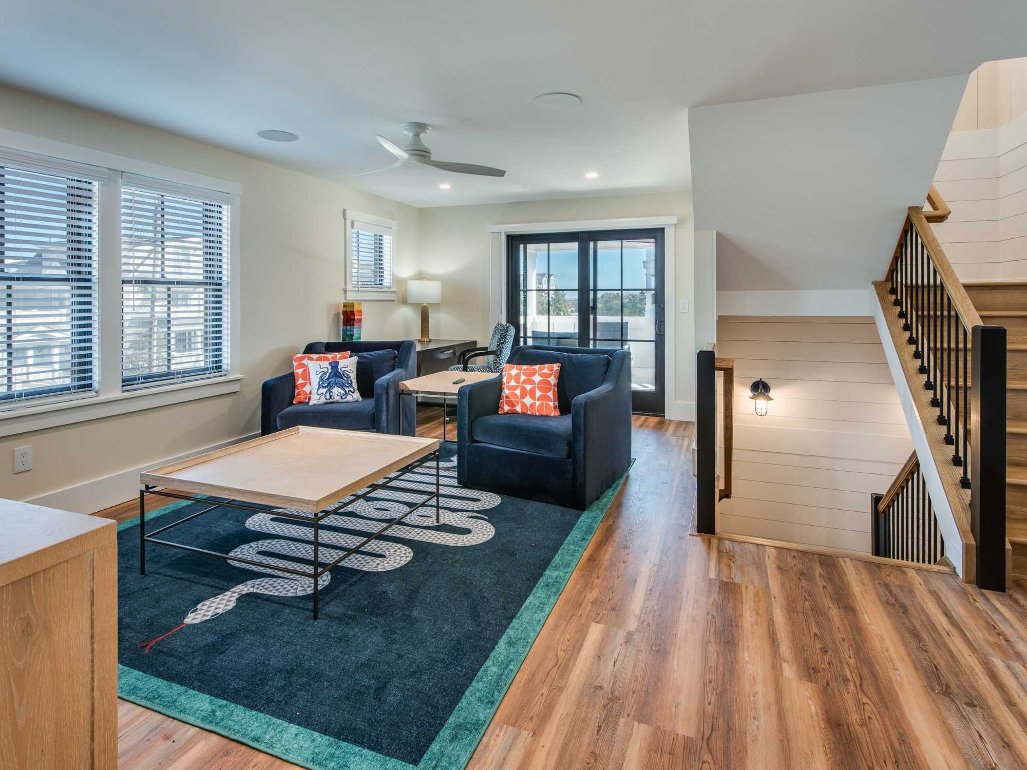 Lounge area on the second floor of a custom home with seating and French doors in Avalon by Thompson Communities Lounge area on the second floor of a custom home with seating and French doors in Avalon by Thompson Communities