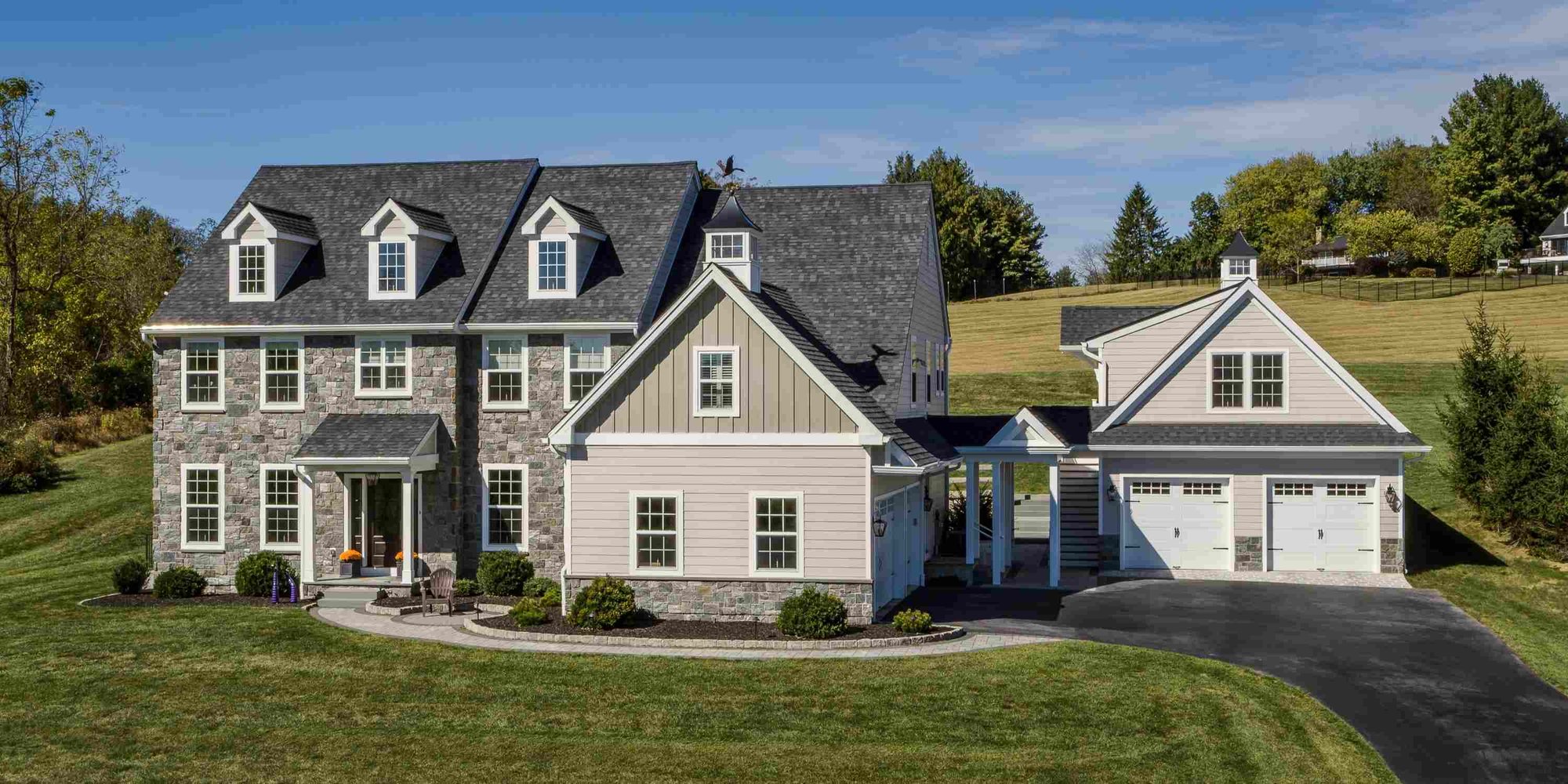 Image of a home with a custom two-story garage built to match the home in West Chester by Thompson Communities Image of a home with a custom two-story garage built to match the home in West Chester by Thompson Communities