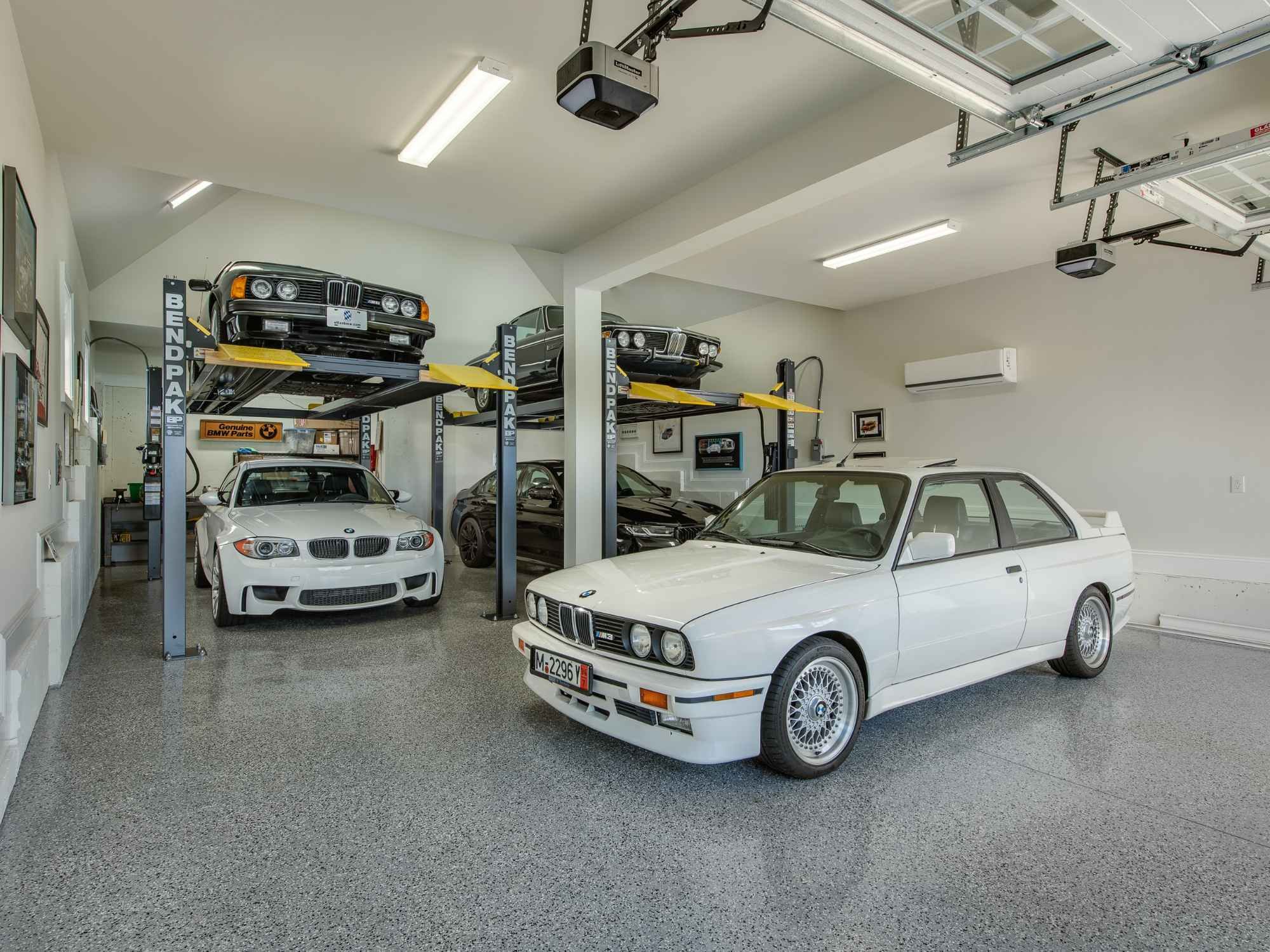 Image of imported cars in a custom garage with lifts in West Chester, PA by Thompson Communities Image of imported cars in a custom garage with lifts in West Chester, PA by Thompson Communities