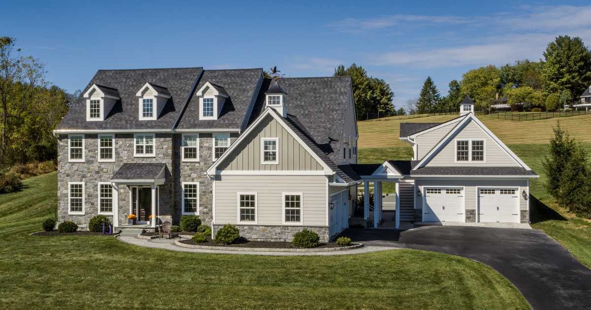 Photo of a home with a custom two-story garage built to match the home in West Chester by Thompson Communities