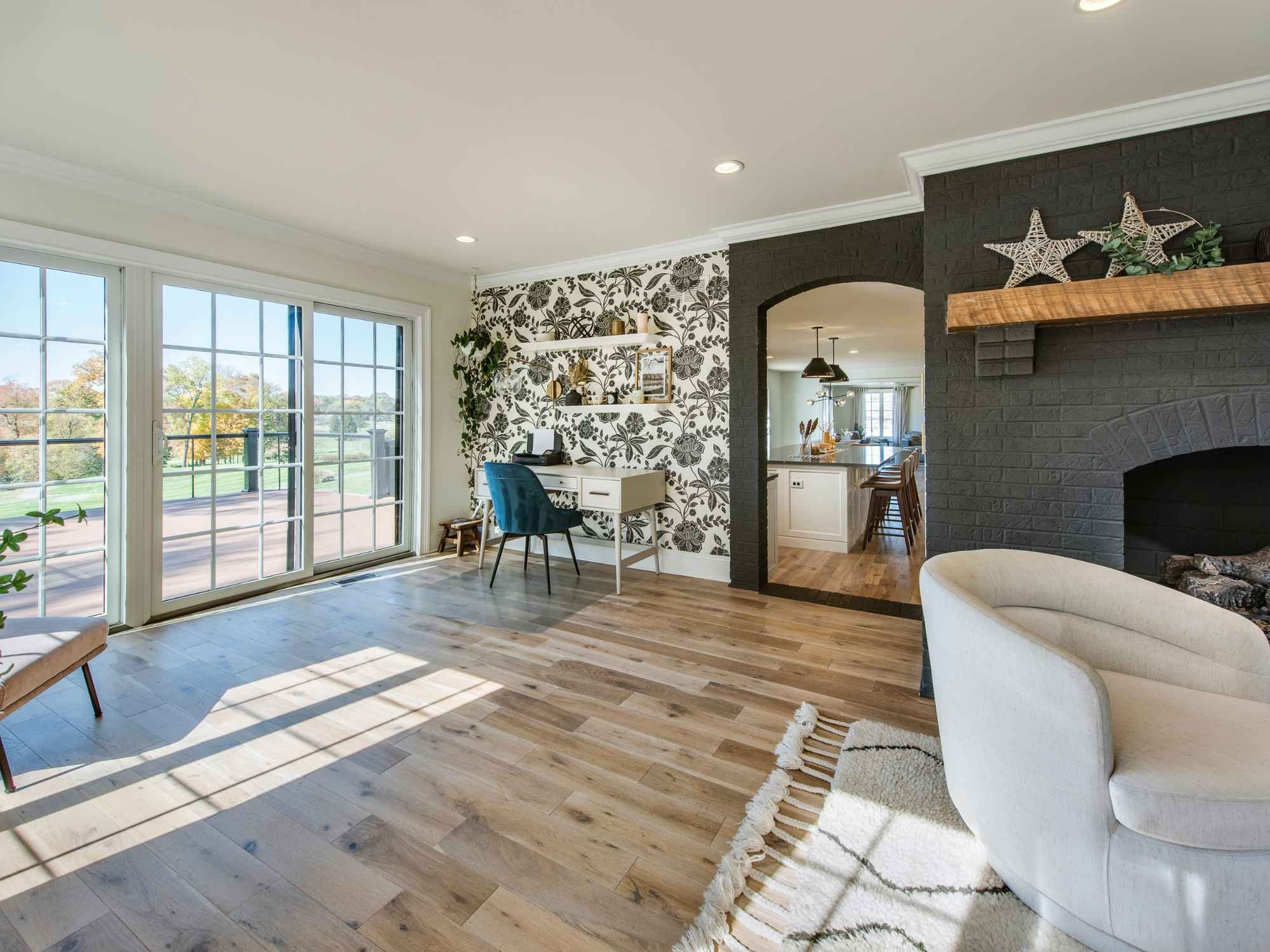 A remodeled living room with wood floors and brick fireplace in West Chester, PA by Thompson Communities