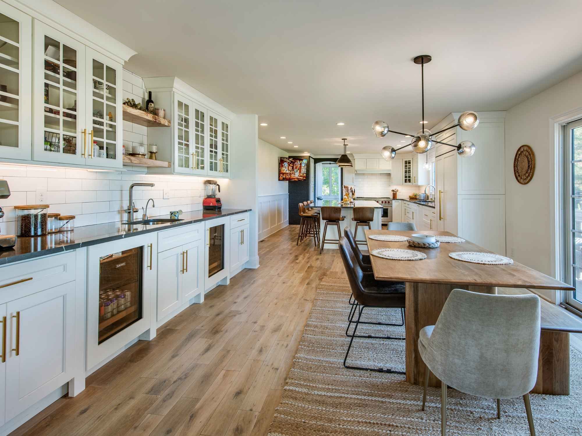 Bright kitchen remodel with white cabinetry, large island, and dining area by Thompson Communities in West Chester, PA