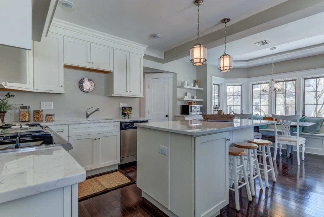 Farmhouse-style kitchen remodel with green granite countertops and classic lighting by Thompson Communities in West Chester, PA