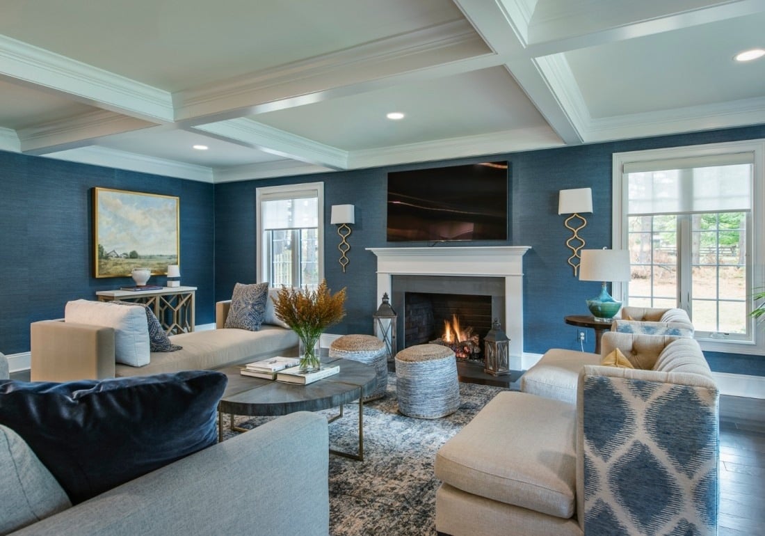 Stylish living room with navy blue walls and a fireplace, remodeled by Thompson Communities, West Chester, PA