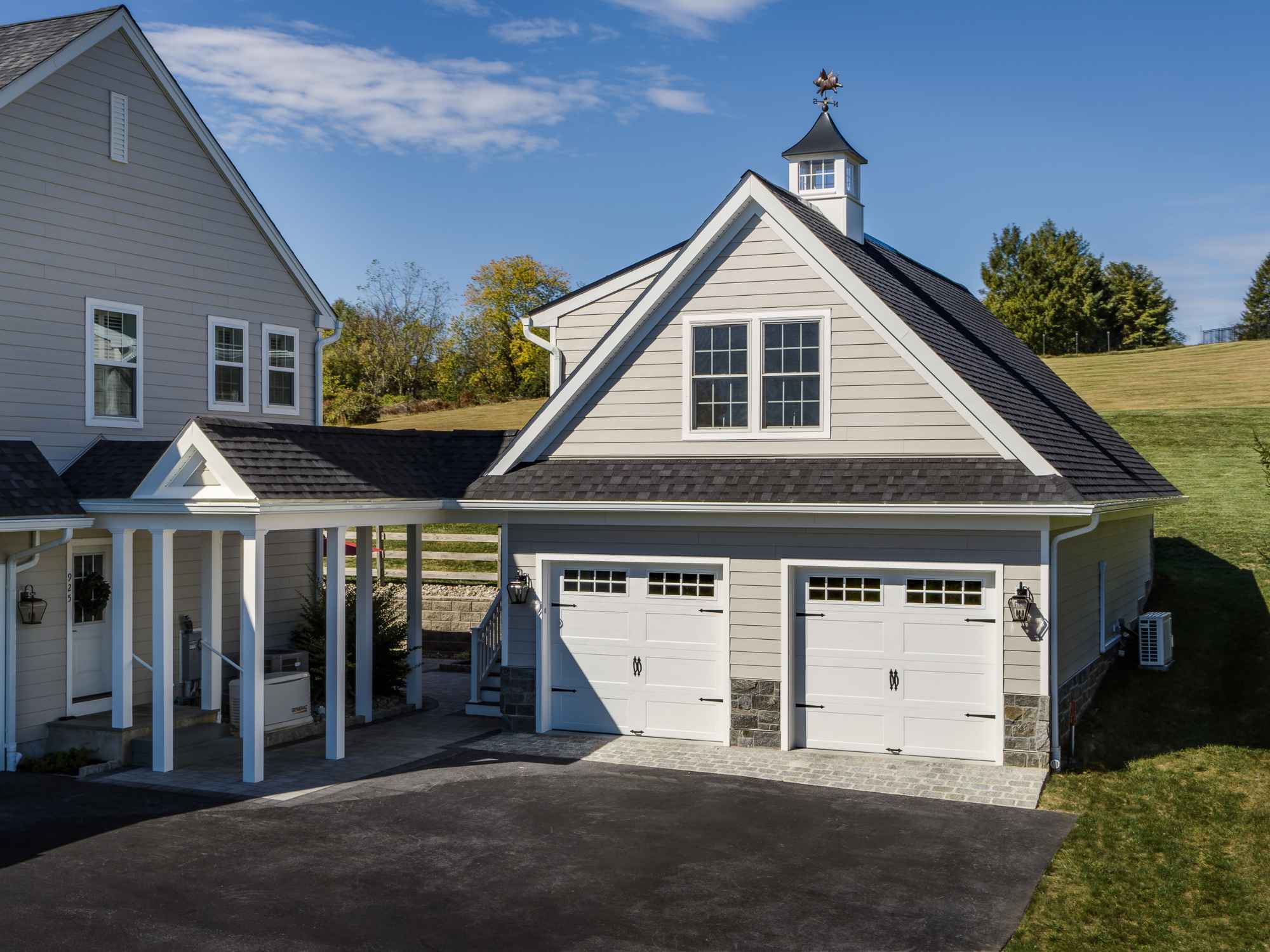 An image of a two-story garage addition built to match the homes design in West Chester by Thompson Communities